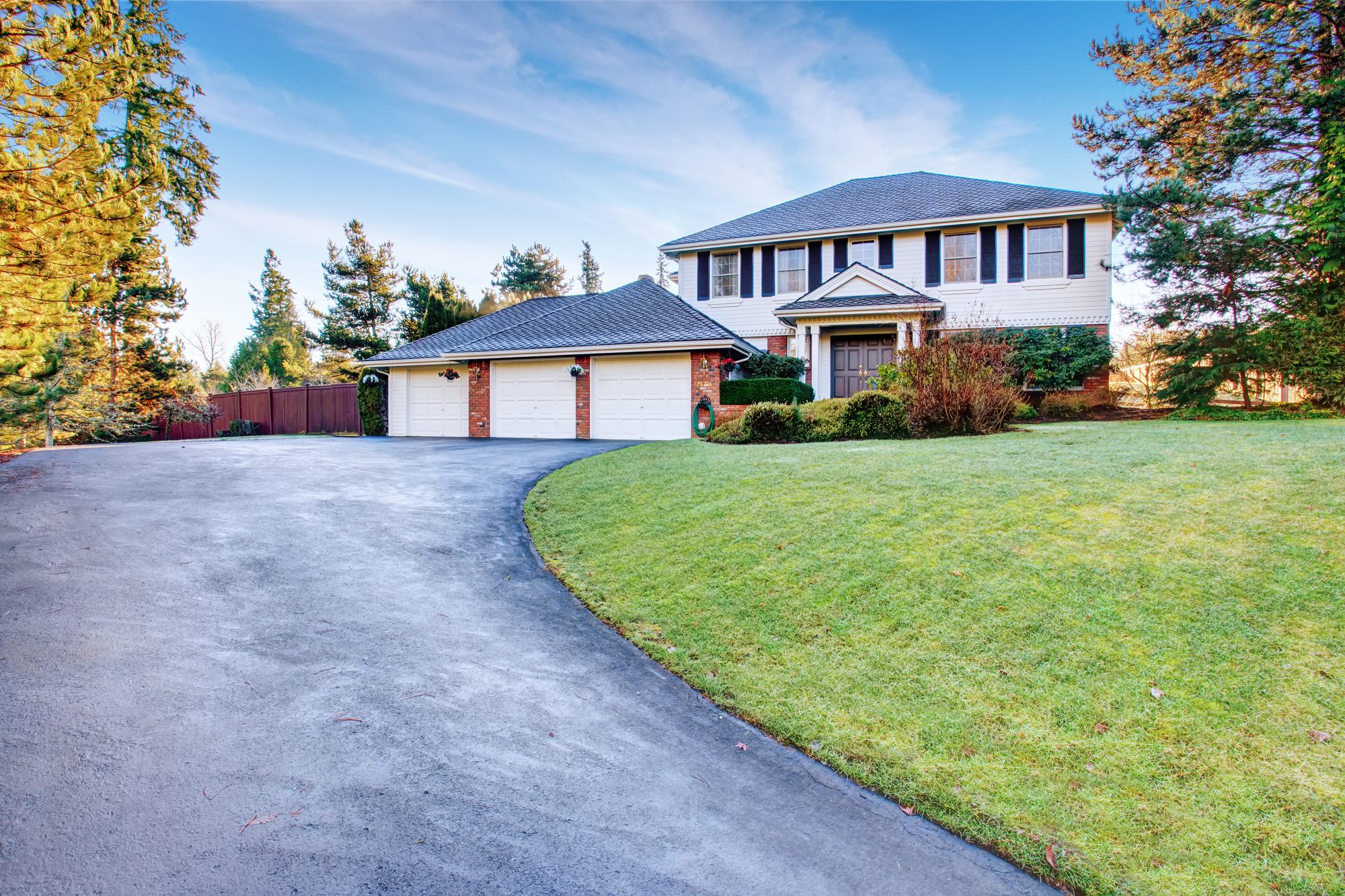 Brick House With Greenery and Nice Driveway.