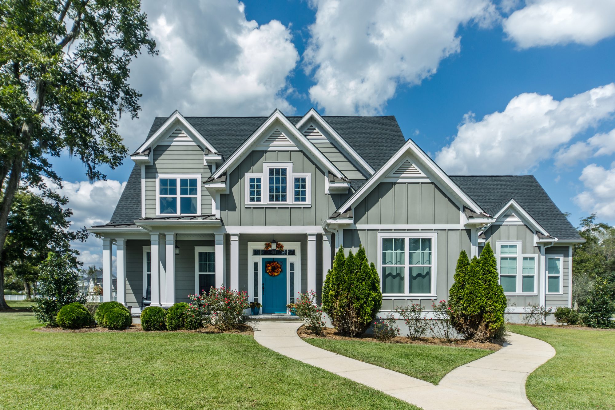 Gray New Construction Modern Cottage Home With Hardy Board Siding and Teal Door